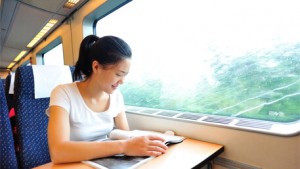 A woman reading a book on a train in China